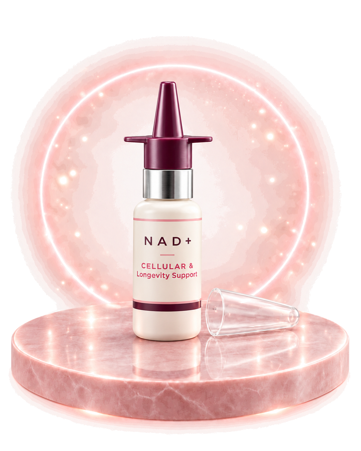 NAD+ nasal spray bottle releasing a fine mist, staged on a pink marble plinth with a glowing ring