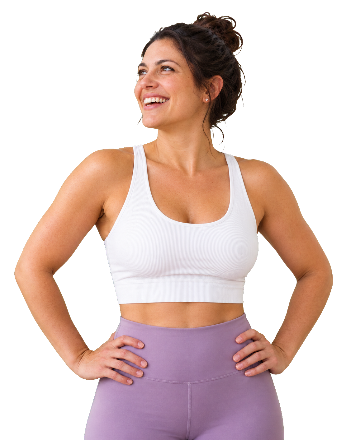 A woman standing with her hands on her hips, smiling and looking away from the camera